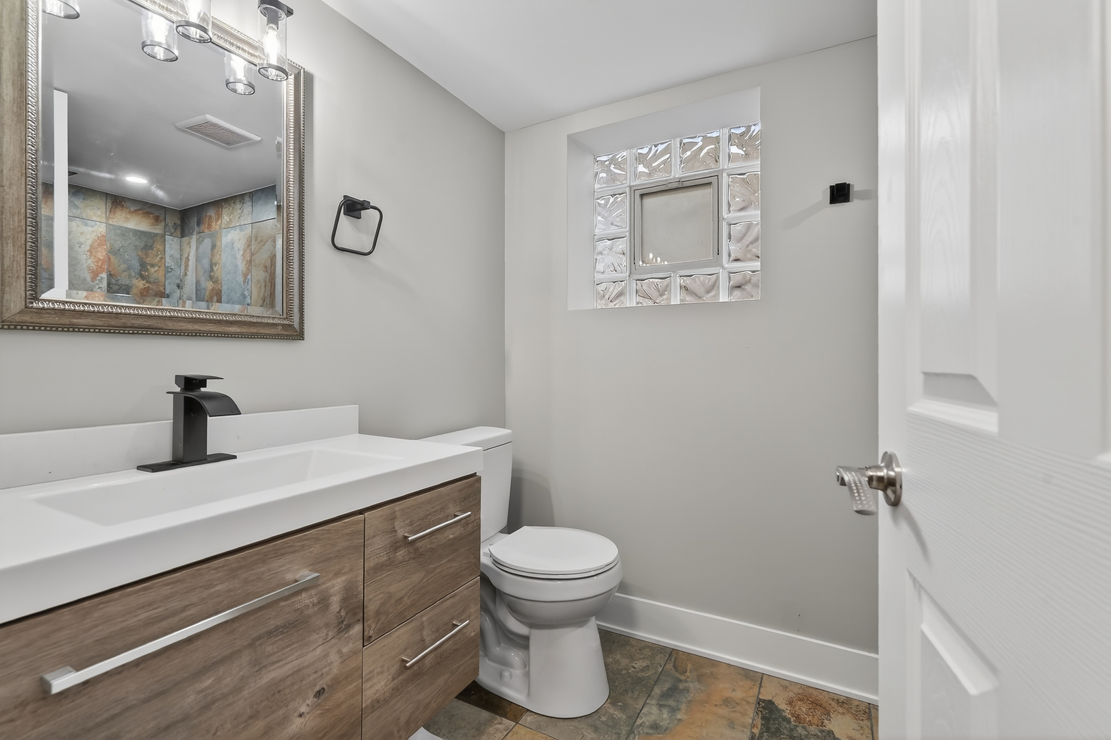515 West 146th Street Dolton, IL 60419 - Photo 23 of 47 a bathroom with a sink a toilet and a mirror