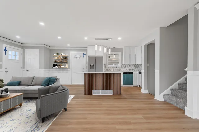 a living room with furniture and kitchen view