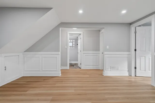 a utility room with cabinets and wooden floor