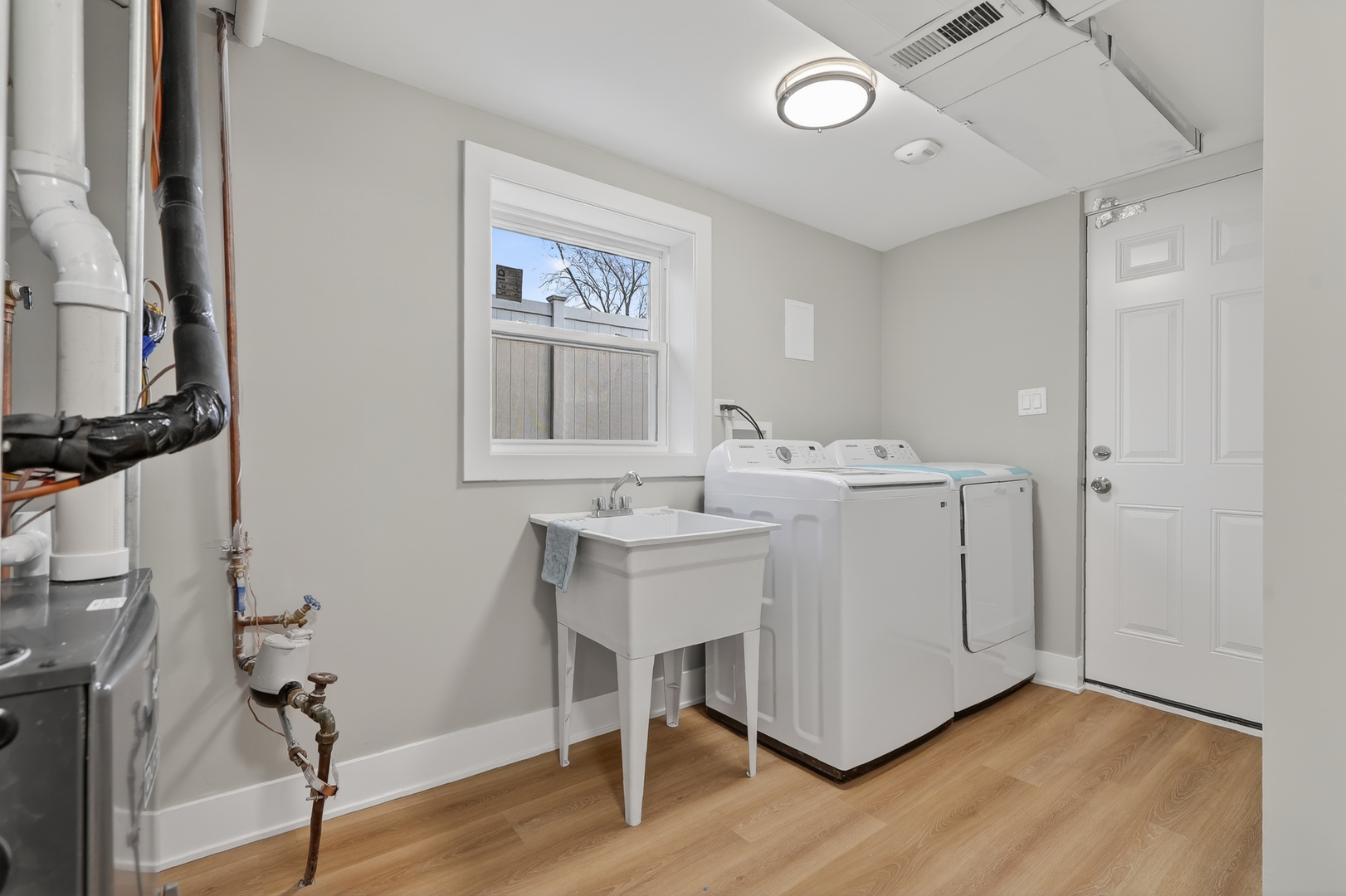 515 West 146th Street Dolton, IL 60419 - Photo 33 of 47 a utility room with cabinets and wooden floor