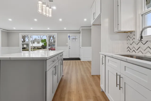 a kitchen with a sink stove and cabinets