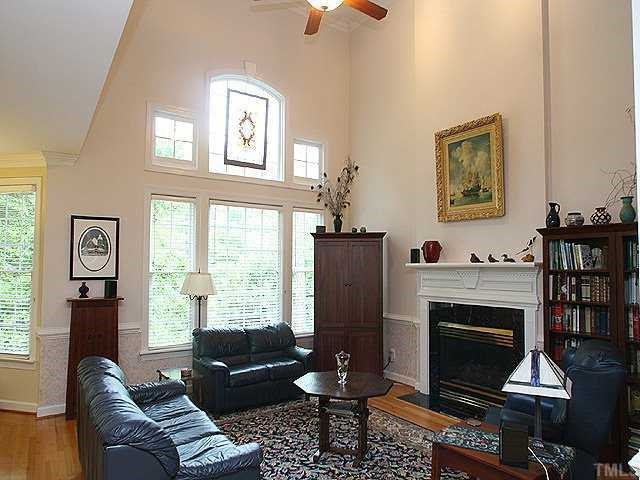2329 Primrose Valley Court Raleigh, NC 27613 - Photo 2 of 12 An open, two story family room features hardwoods, a gas log fireplace, and a ceiling fan. Den/Family/Great Room