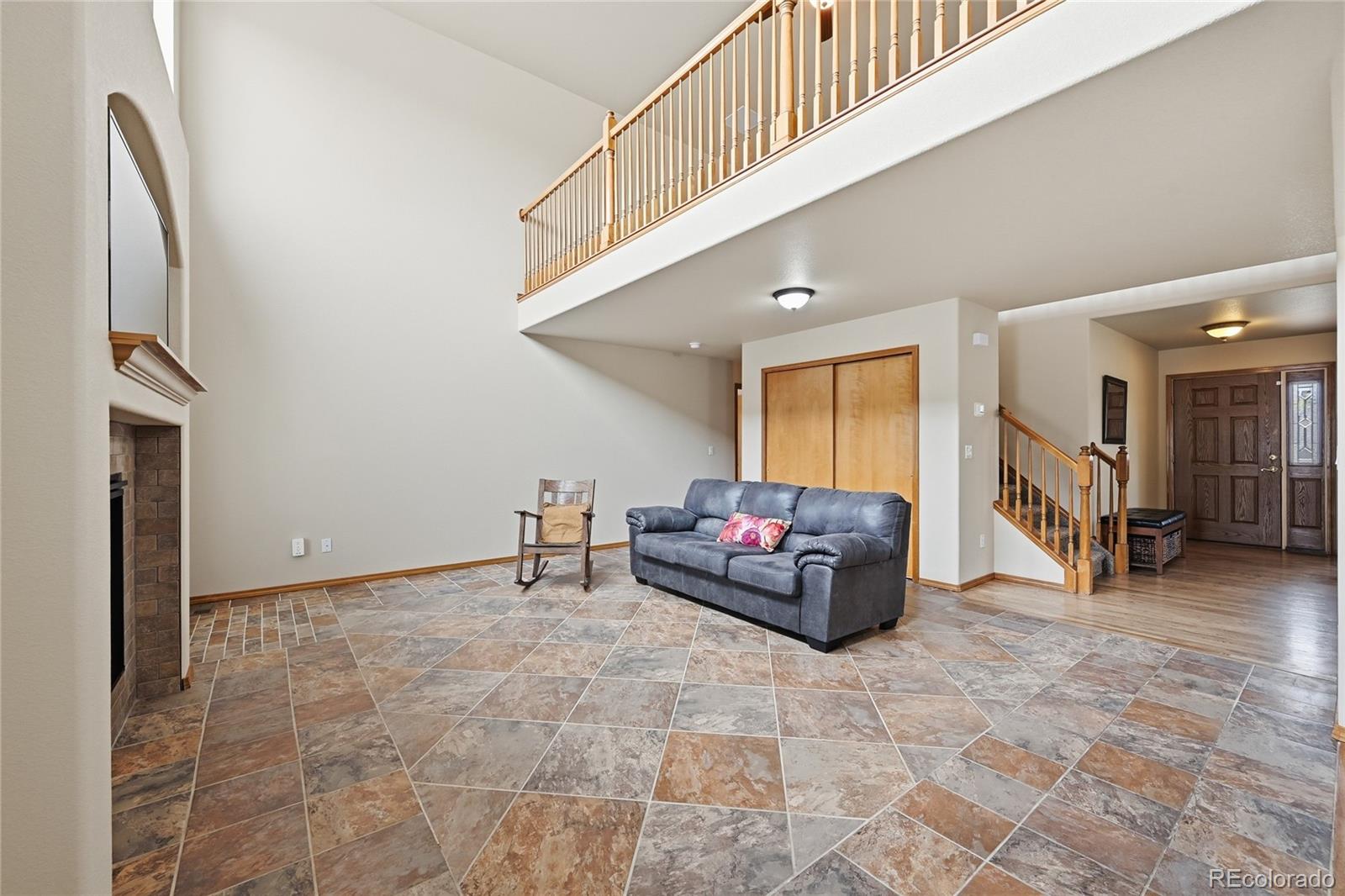 9288 Rockingham Drive Peyton, CO 80831 - Photo 9 of 49 a living room with furniture and a flat screen tv