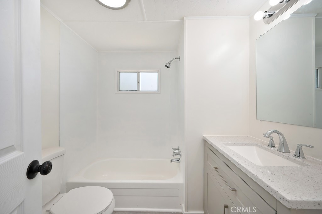 26455 Paradise Valley Road, Unit 86 Warner Springs, CA 92086 - Photo 24 of 34 a bathroom with a granite countertop sink toilet and bathtub