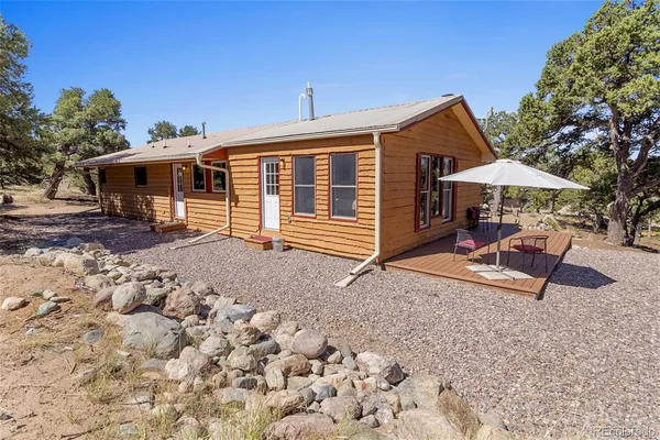 a view of a house with backyard and sitting area