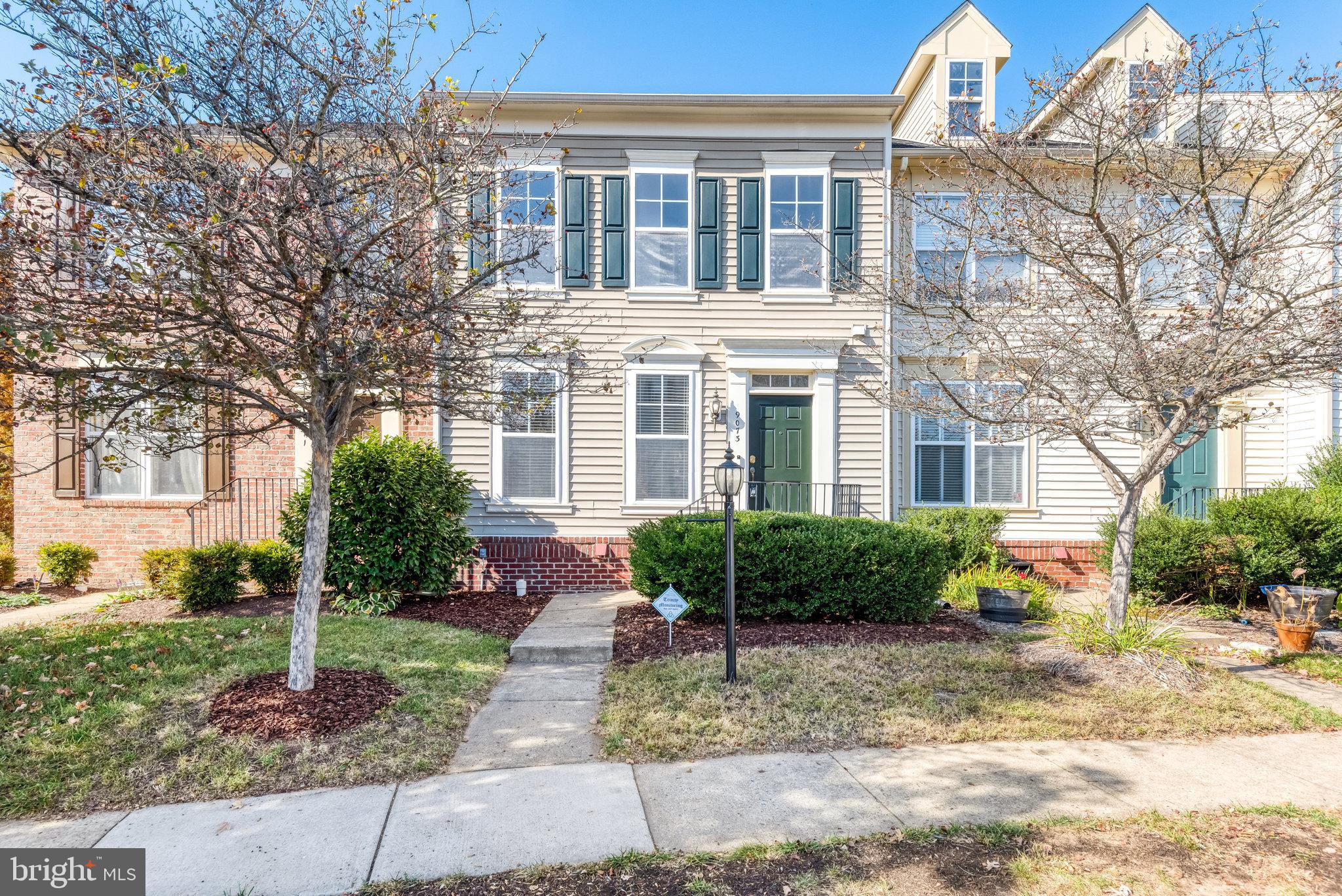 a front view of a house with garden and plants