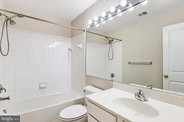 a bathroom with a sink toilet tub and shower