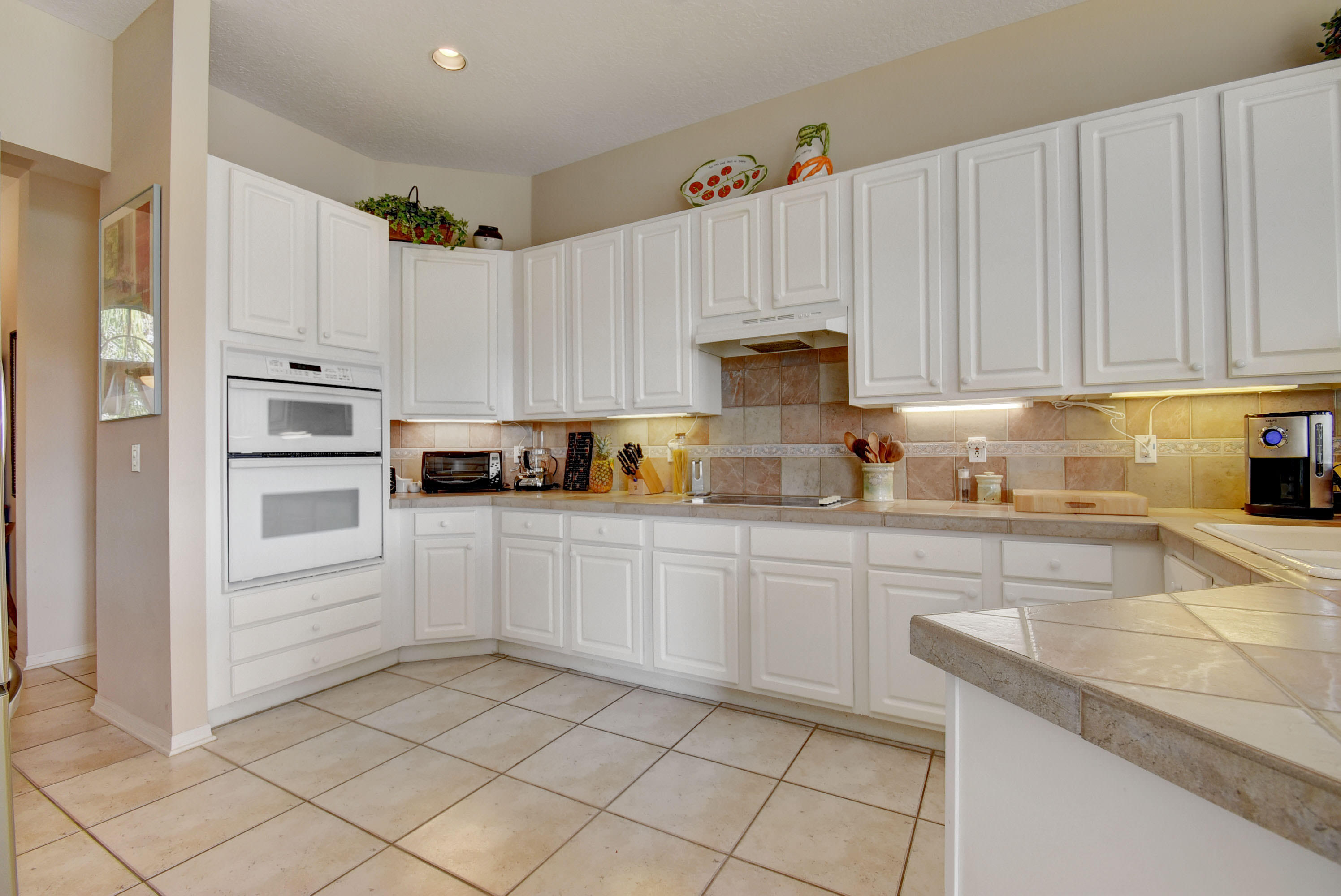 21587 Halstead Drive Boca Raton, FL 33428 - Photo 15 of 53 a kitchen with granite countertop white cabinets and white appliances