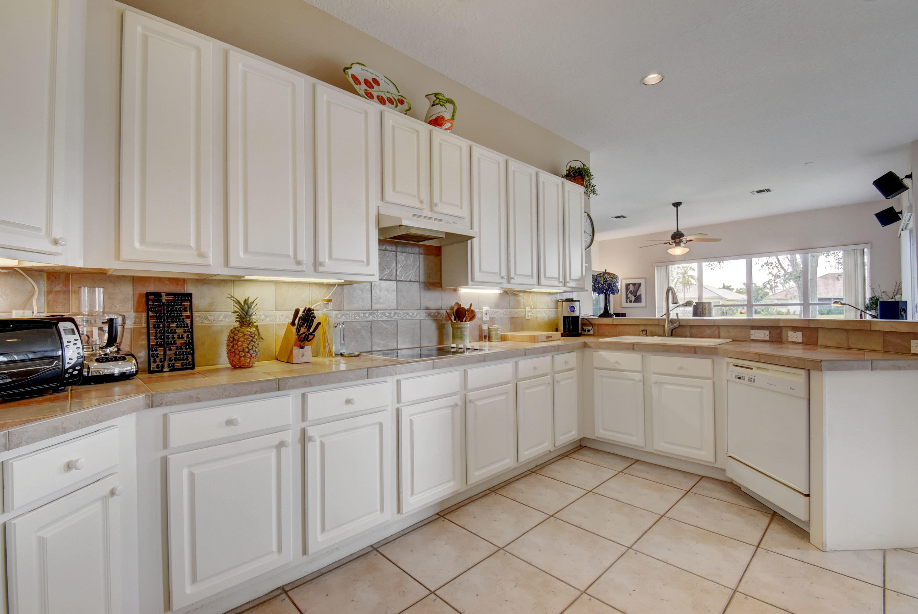 21587 Halstead Drive Boca Raton, FL 33428 - Photo 16 of 53 a kitchen with white cabinets and white appliances
