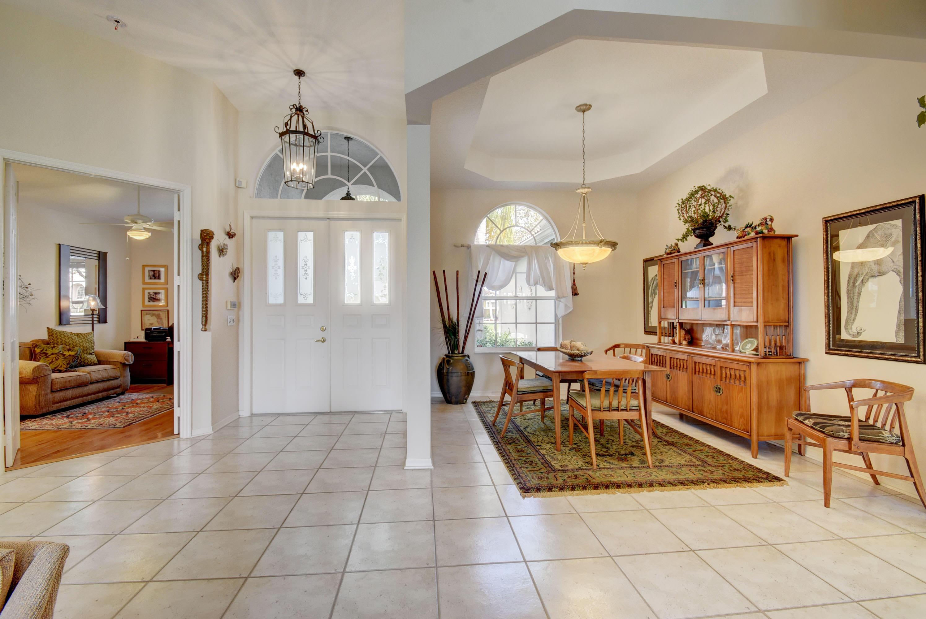 21587 Halstead Drive Boca Raton, FL 33428 - Photo 4 of 53 a view of a dining room and hall with a chandelier