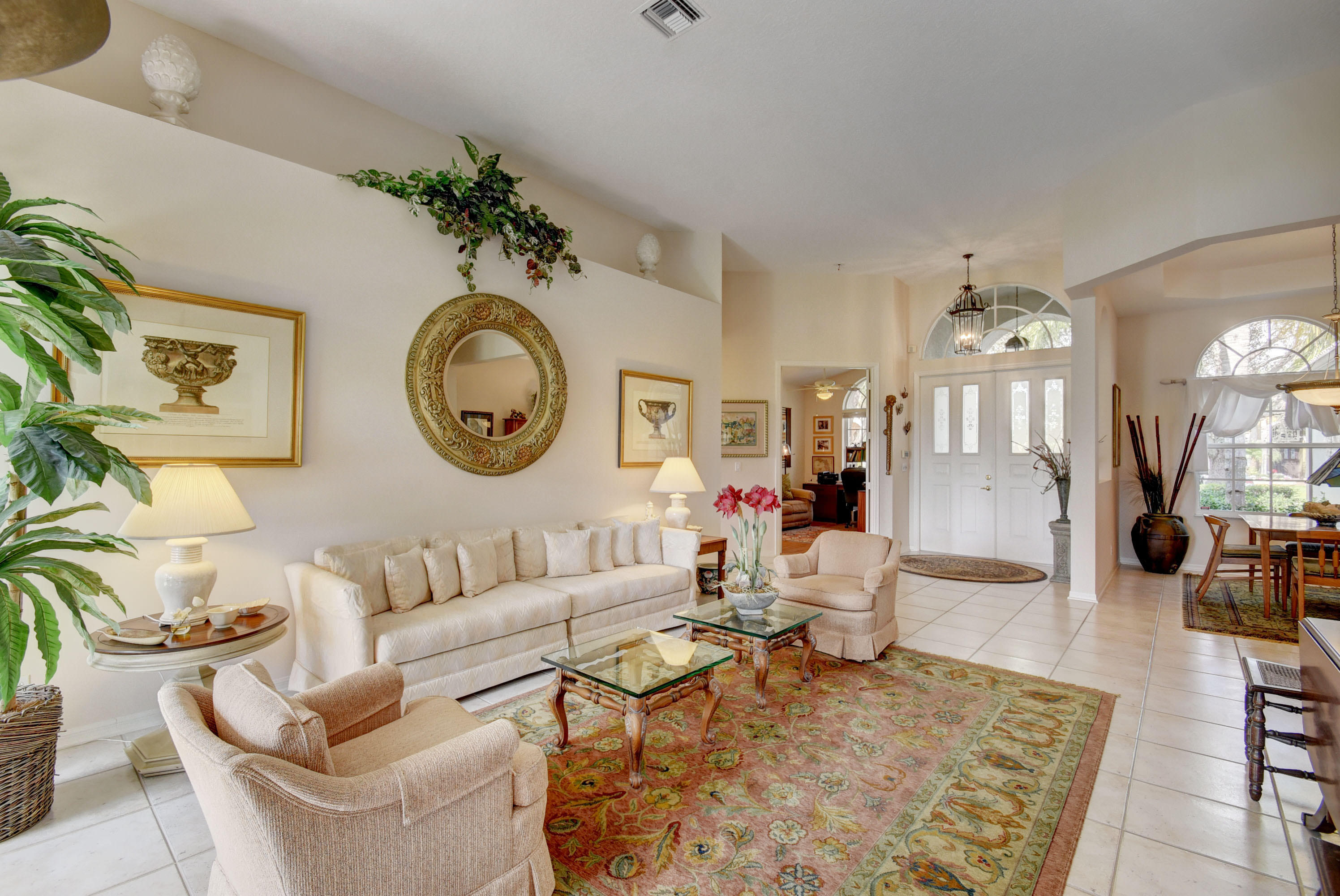 21587 Halstead Drive Boca Raton, FL 33428 - Photo 7 of 53 a living room with furniture a chandelier a mirror and a large mirror