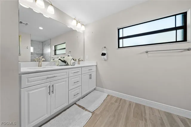 a workspace with wooden floor and a ceiling fan