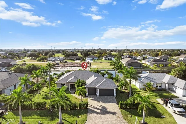 an aerial view of multiple houses with yard