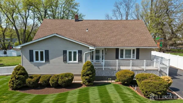 a view of house with backyard