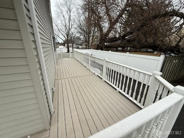 a view of deck with wooden floor and fence and a floor to ceiling window