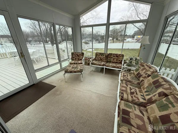 a living room with furniture and a floor to ceiling window