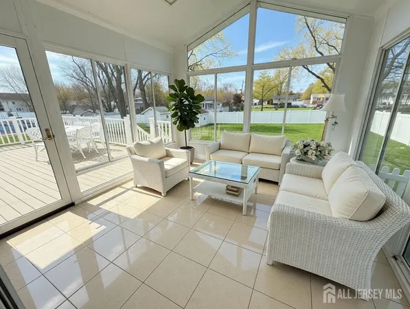 a living room with furniture and a floor to ceiling window