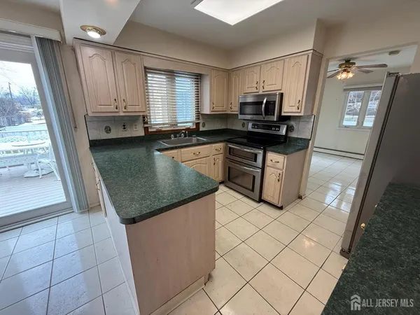 a kitchen with granite countertop a sink and a stove top oven