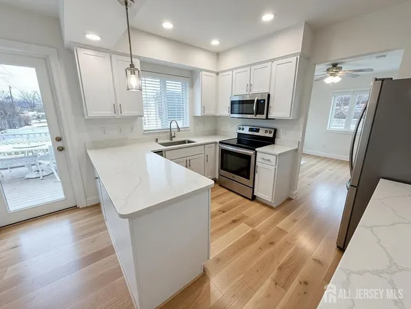 a kitchen with granite countertop a sink and steel appliances