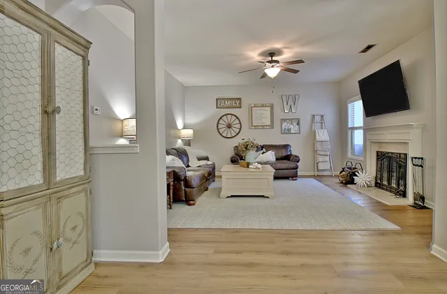 a living room with furniture a fireplace and a flat screen tv