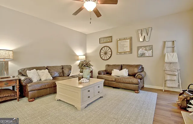 a living room with furniture and a chandelier