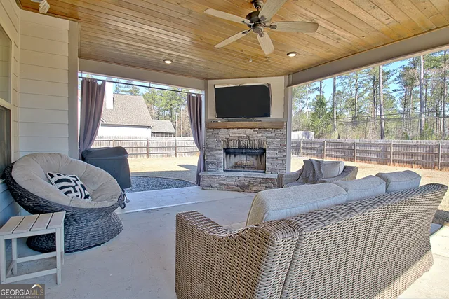 a living room with furniture a fireplace and a flat screen tv