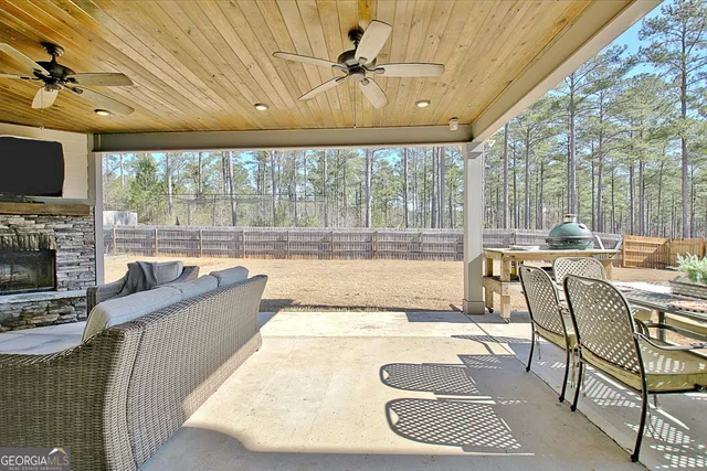 a outdoor living space with furniture and a rug