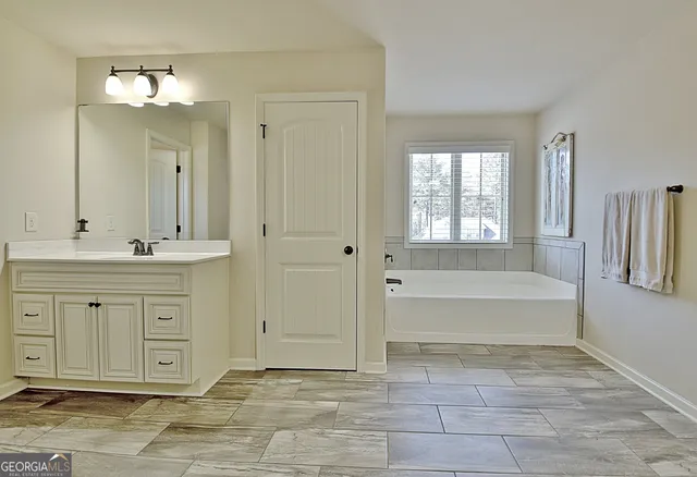 a bathroom with a granite countertop sink toilet a mirror and shower