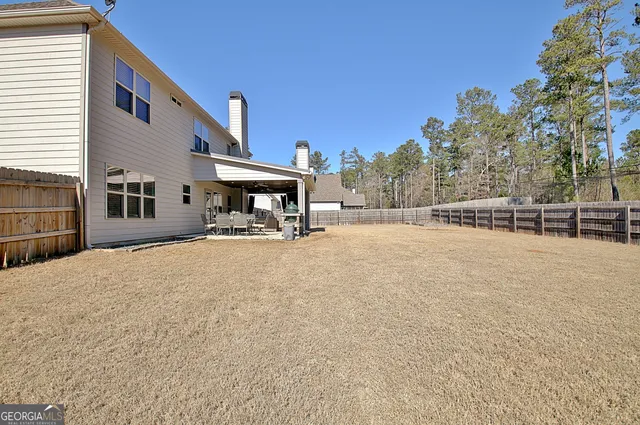 an aerial view of a house with a yard basket ball court and outdoor seating