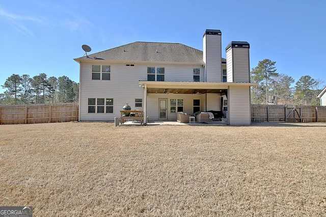 a view of a swimming pool with an outdoor seating and trees