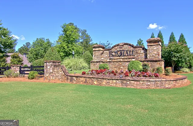a front view of a house with yard and a trees