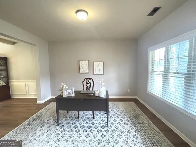 a dining room with furniture a chandelier and wooden floor
