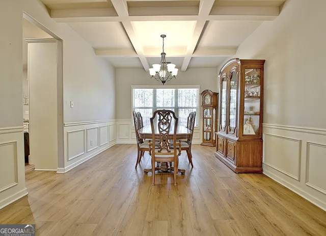 a kitchen with stainless steel appliances granite countertop a sink dishwasher a stove and white cabinets with wooden floor