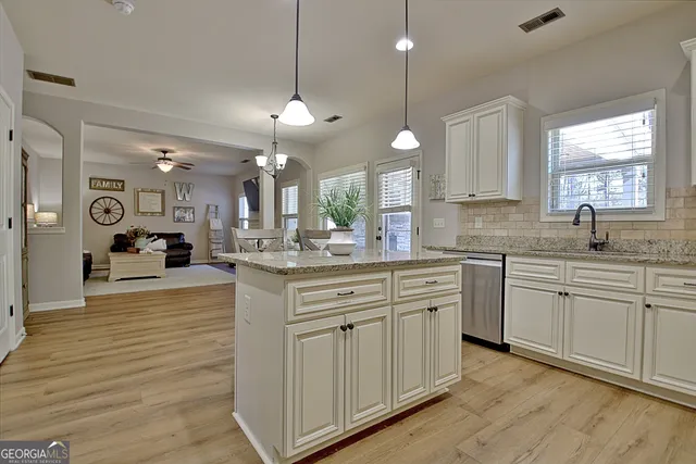 a kitchen with stainless steel appliances granite countertop a sink and cabinets