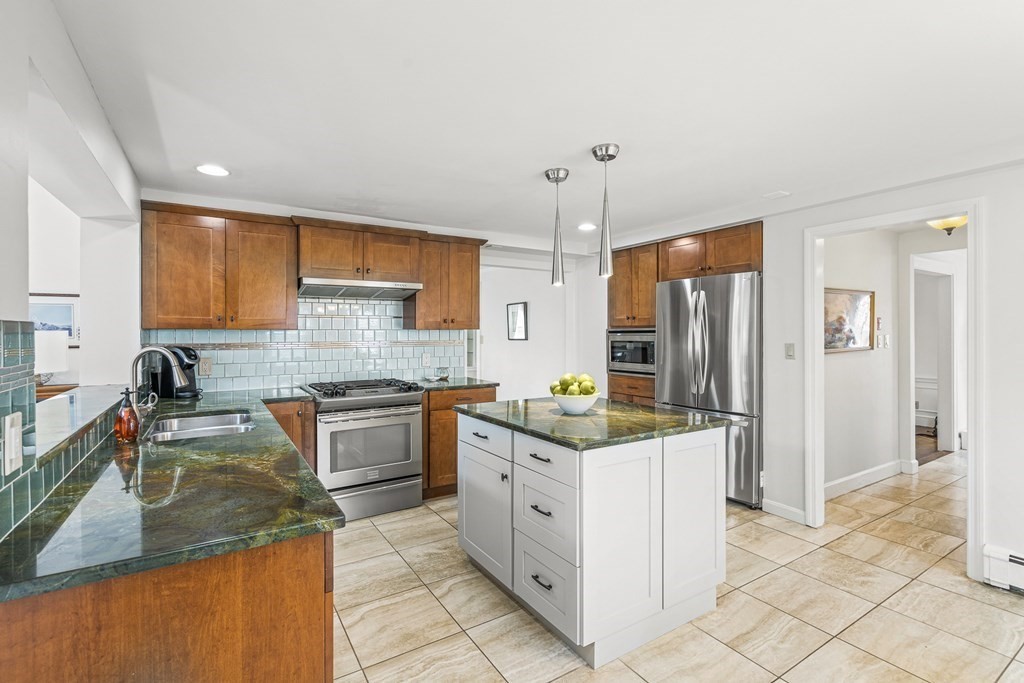 3 Laird Road Medford, MA 02155 - Photo 12 of 42 a kitchen with a sink stove and refrigerator
