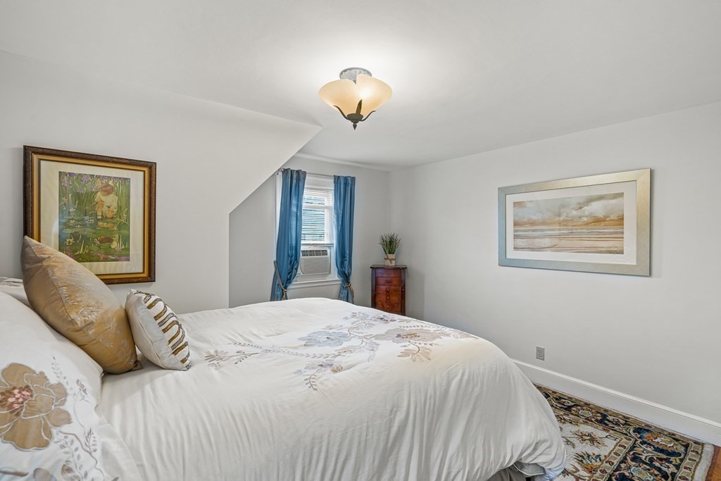 3 Laird Road Medford, MA 02155 - Photo 23 of 42 a bedroom with a large bed and a window