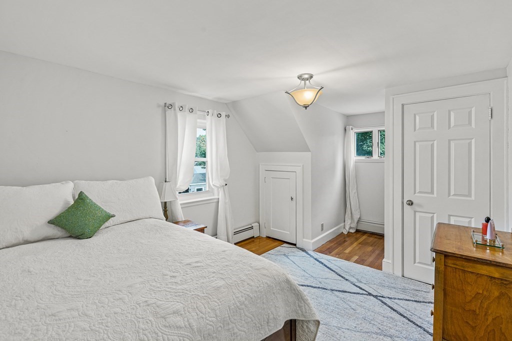 3 Laird Road Medford, MA 02155 - Photo 24 of 42 a bedroom with a bed and a chandelier