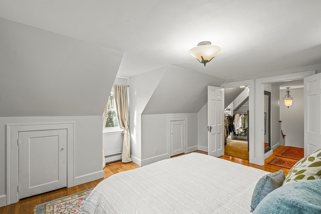 3 Laird Road Medford, MA 02155 - Photo 26 of 42 a bedroom with a bed and a chandelier