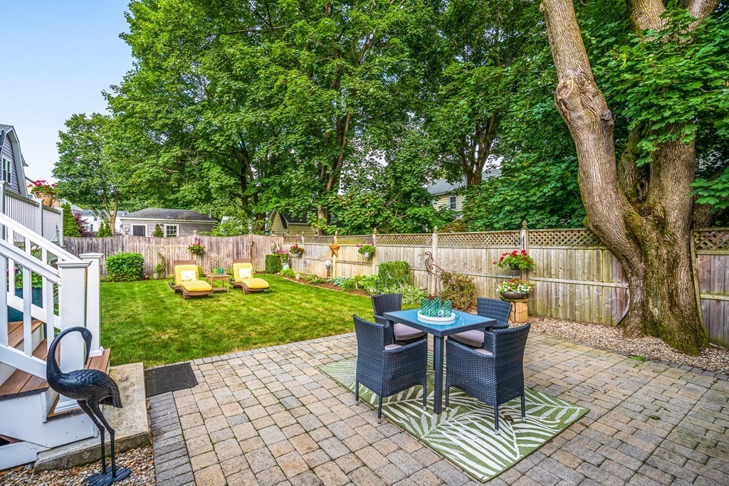 3 Laird Road Medford, MA 02155 - Photo 37 of 42 a view of a patio with table and chairs potted plants and large tree
