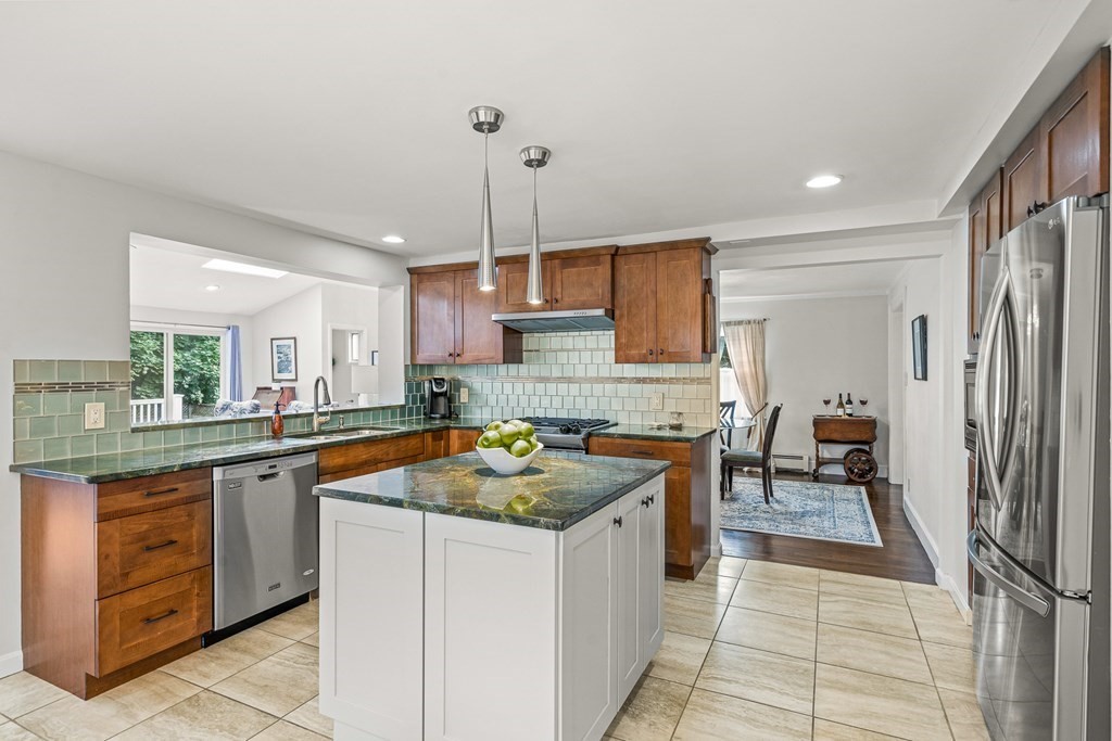 3 Laird Road Medford, MA 02155 - Photo 8 of 42 a kitchen with stainless steel appliances granite countertop a sink and a refrigerator