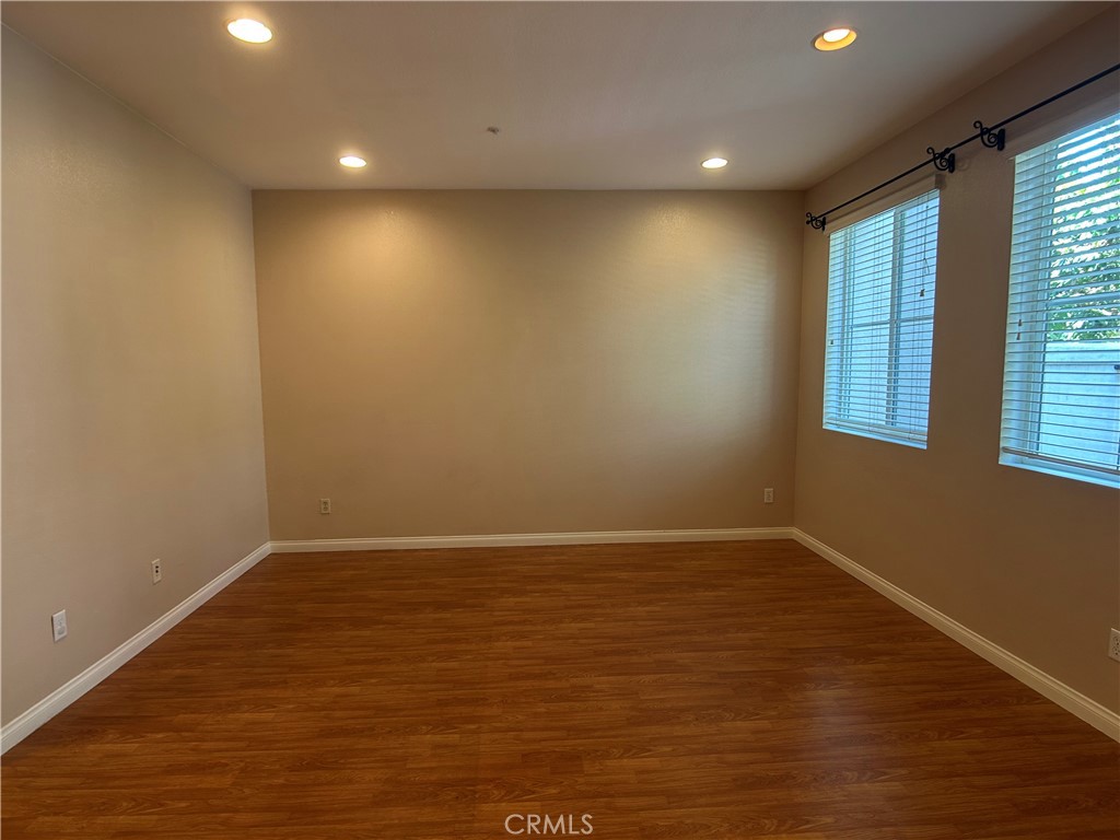 23 Cameron, Unit 67 Irvine, CA 92602 - Photo 5 of 15 an empty room with wooden floor and windows