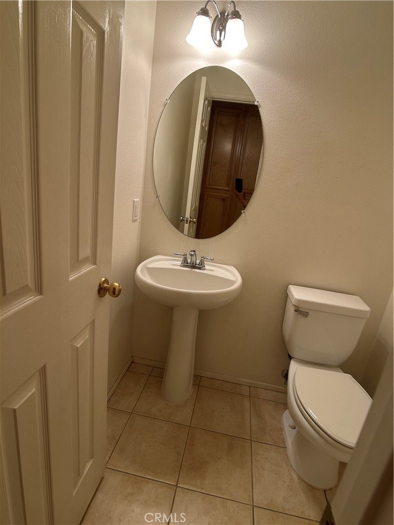 23 Cameron, Unit 67 Irvine, CA 92602 - Photo 7 of 15 a bathroom with a toilet sink and mirror