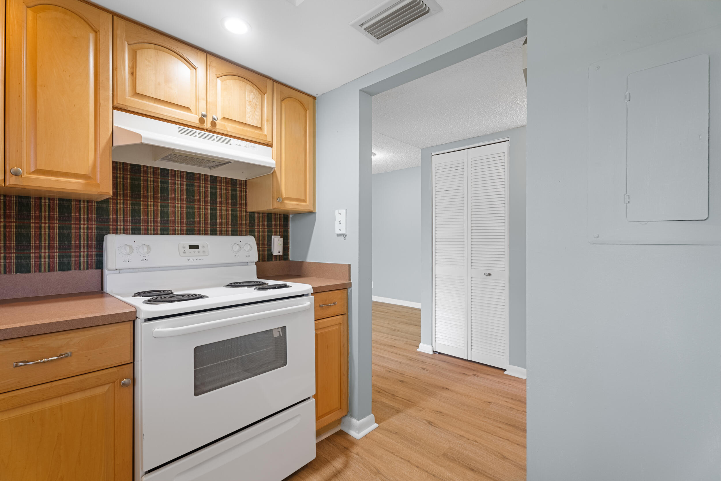 151 Southwest South River Drive, Unit 203 Stuart, FL 34997 - Photo 12 of 54 a view of a kitchen with stove and cabinets