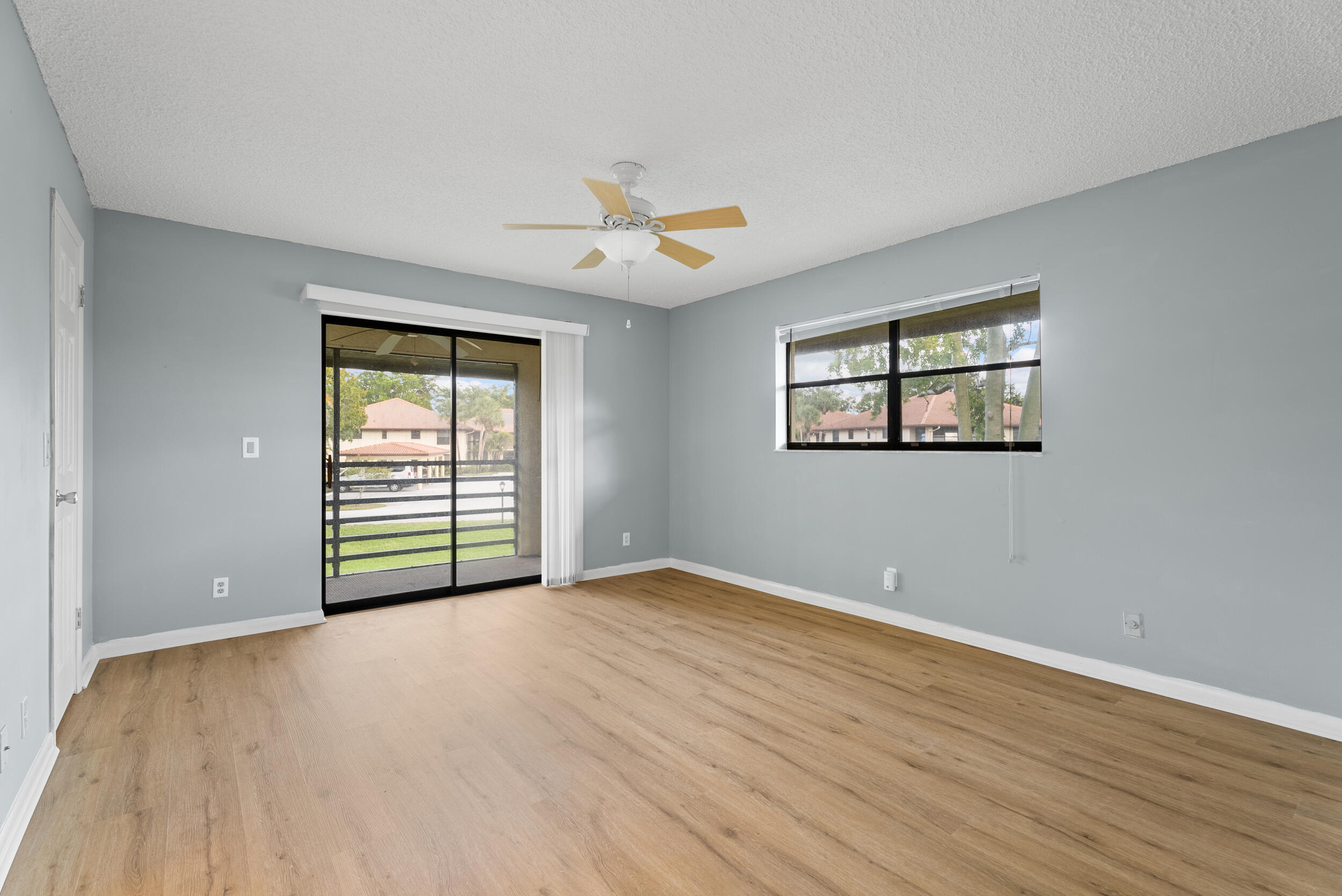 151 Southwest South River Drive, Unit 203 Stuart, FL 34997 - Photo 15 of 54 a view of an empty room with a window and wooden floor