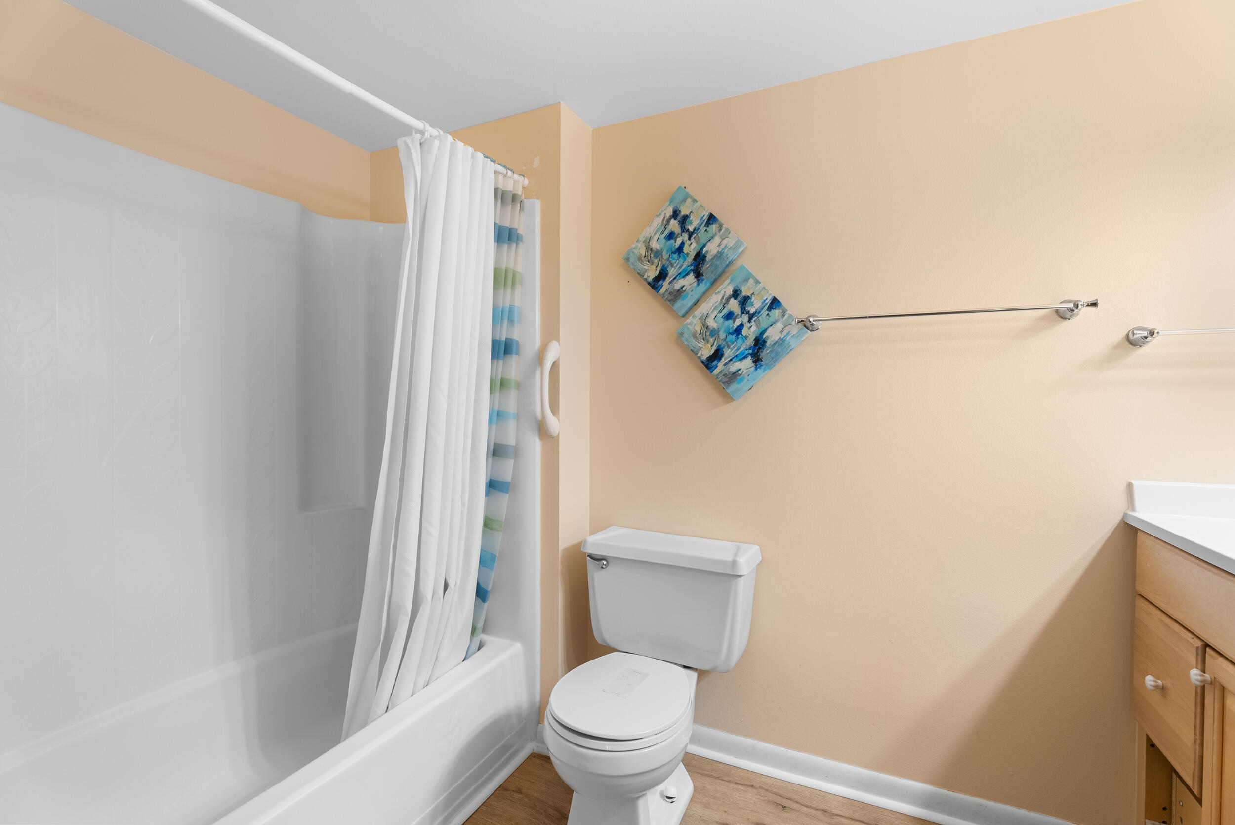 151 Southwest South River Drive, Unit 203 Stuart, FL 34997 - Photo 19 of 54 a white toilet sitting next to a bathroom sink and a shower