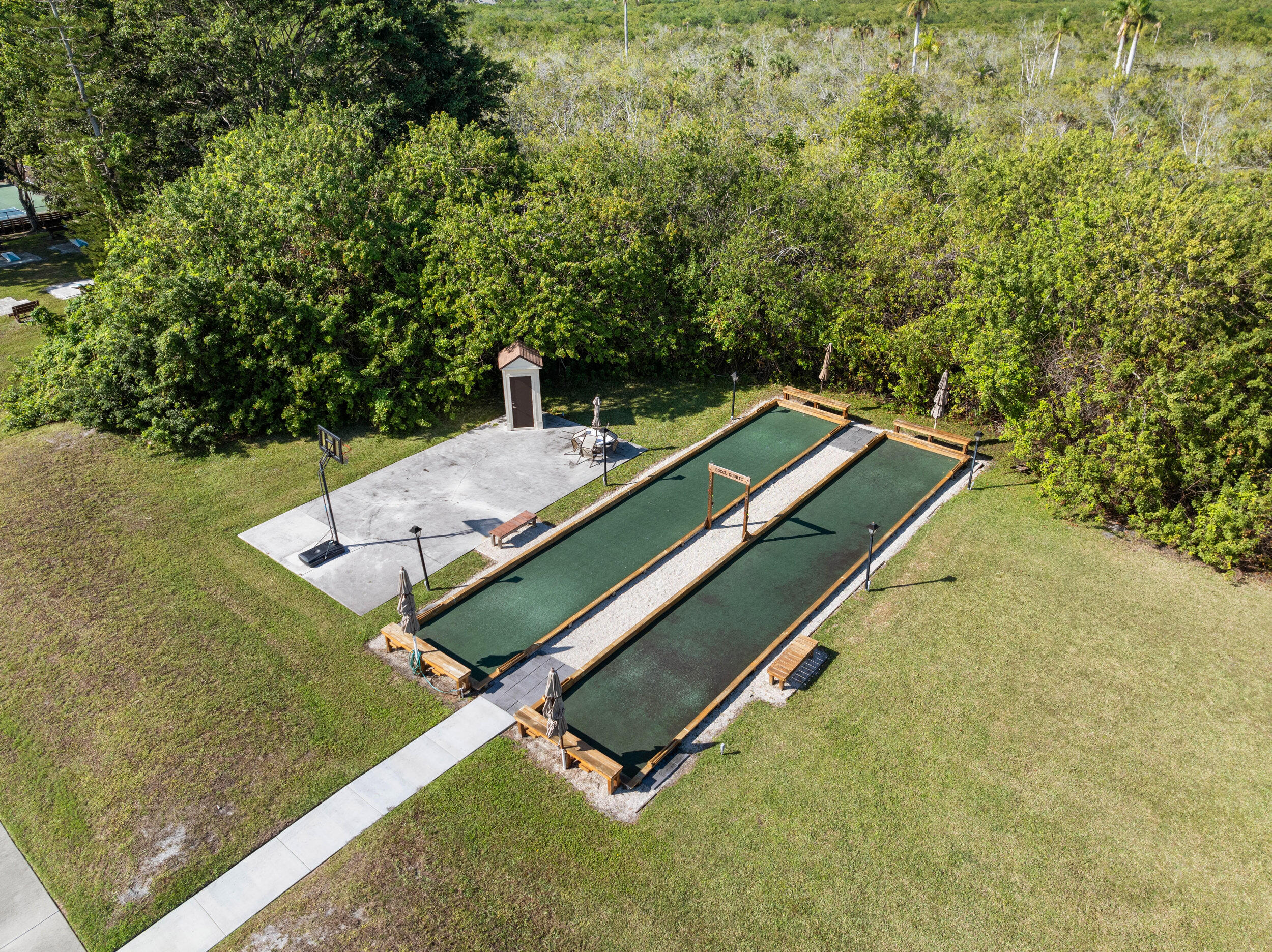 151 Southwest South River Drive, Unit 203 Stuart, FL 34997 - Photo 29 of 54 a bench sitting in the middle of a field