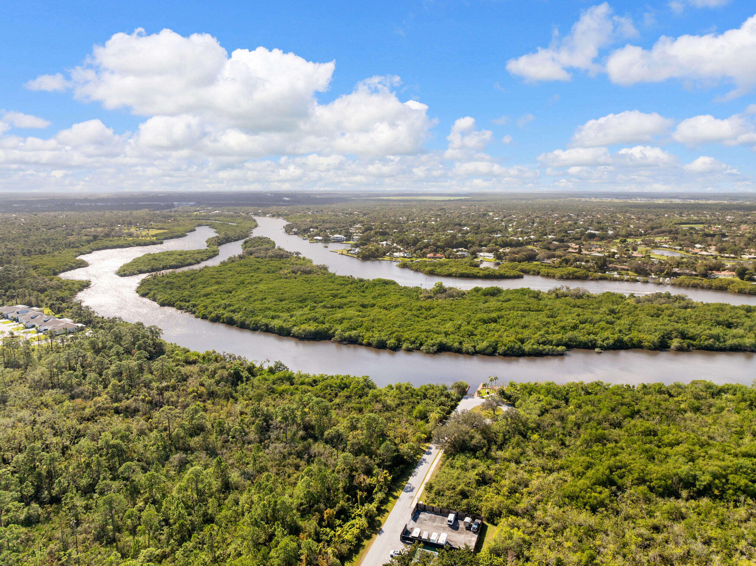 151 Southwest South River Drive, Unit 203 Stuart, FL 34997 - Photo 32 of 54 a view of a lake with houses in the back