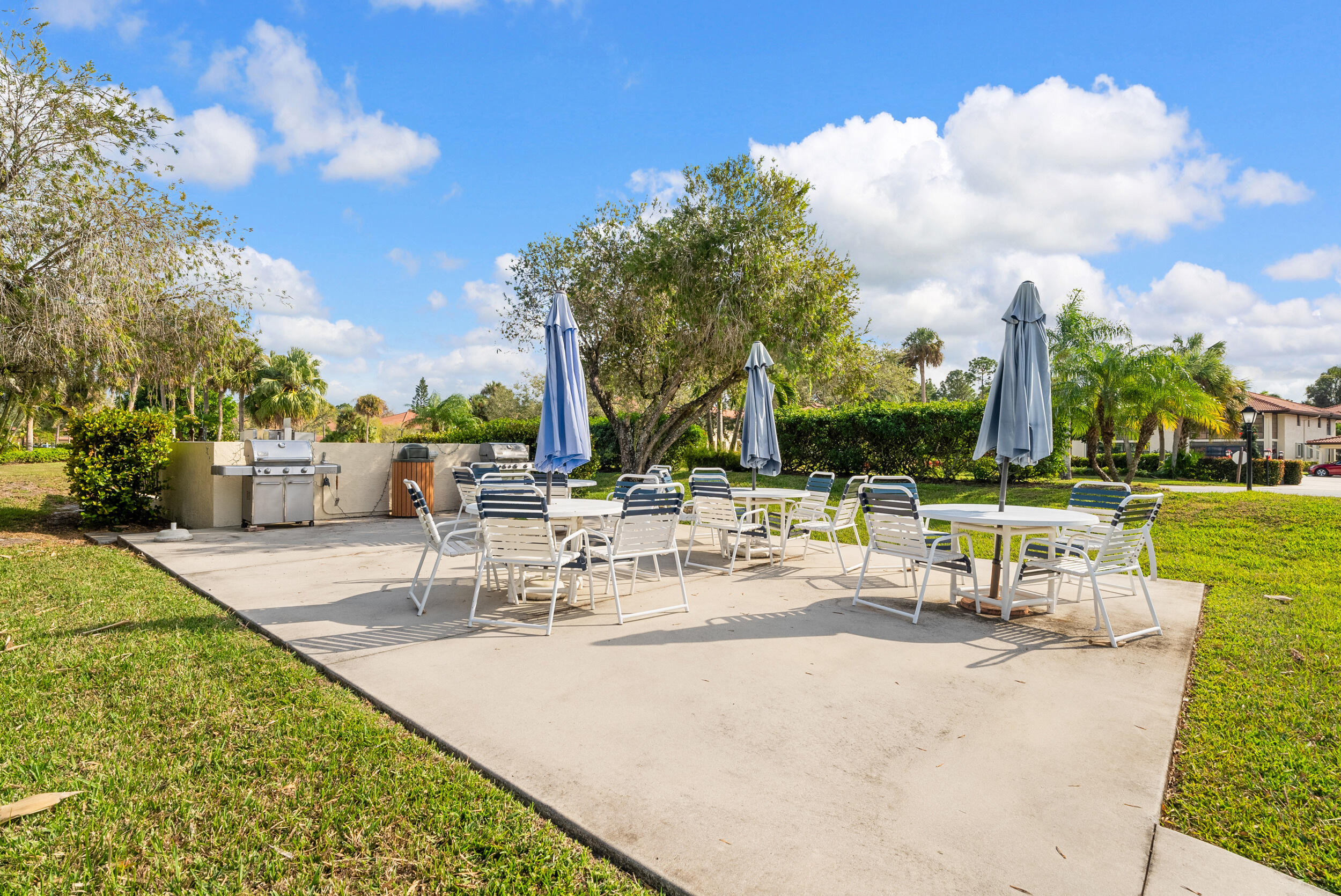 151 Southwest South River Drive, Unit 203 Stuart, FL 34997 - Photo 33 of 54 a view of a swimming pool with tables and chairs