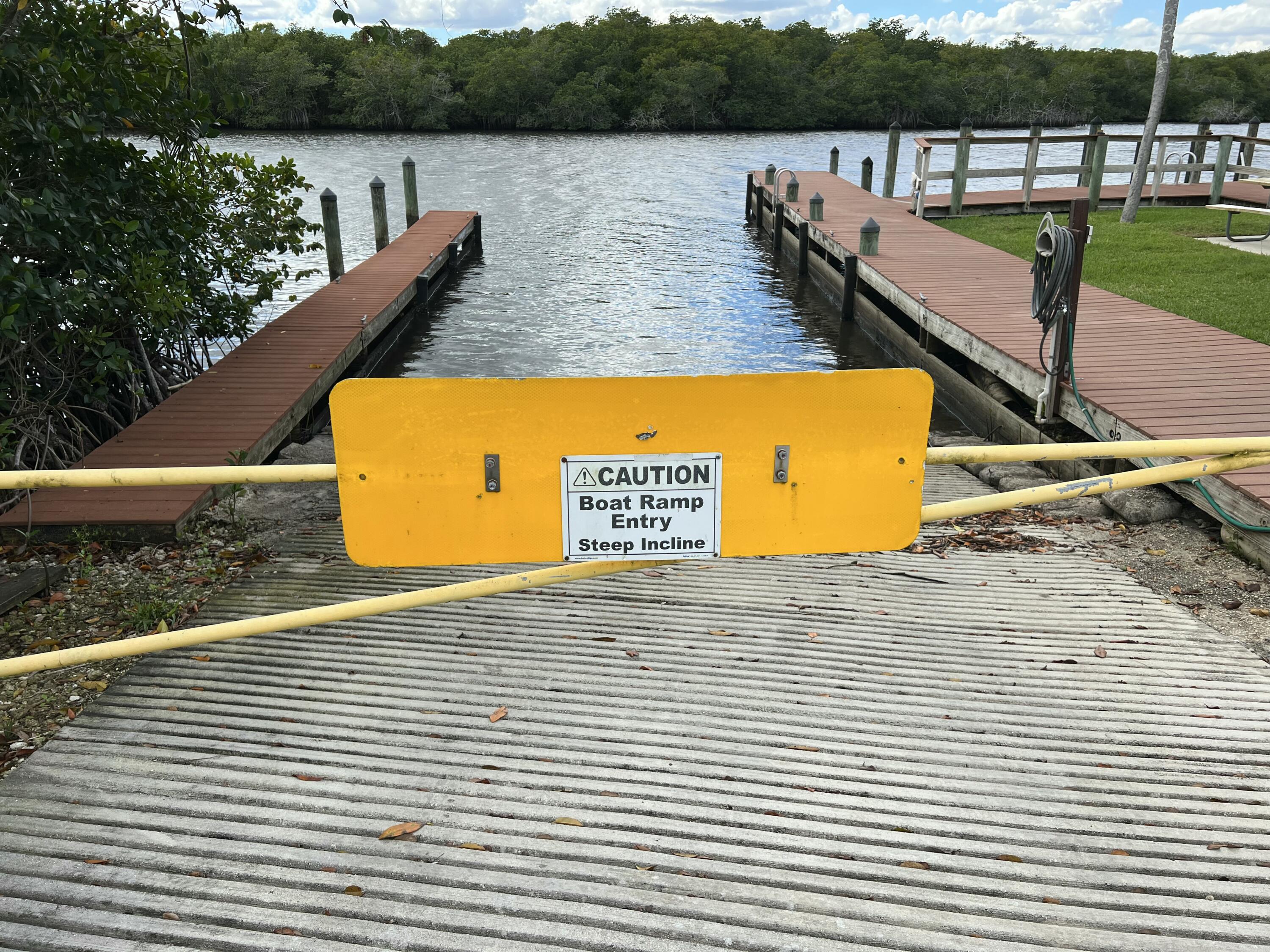 151 Southwest South River Drive, Unit 203 Stuart, FL 34997 - Photo 37 of 54 a view of a lake with couches chairs in the patio