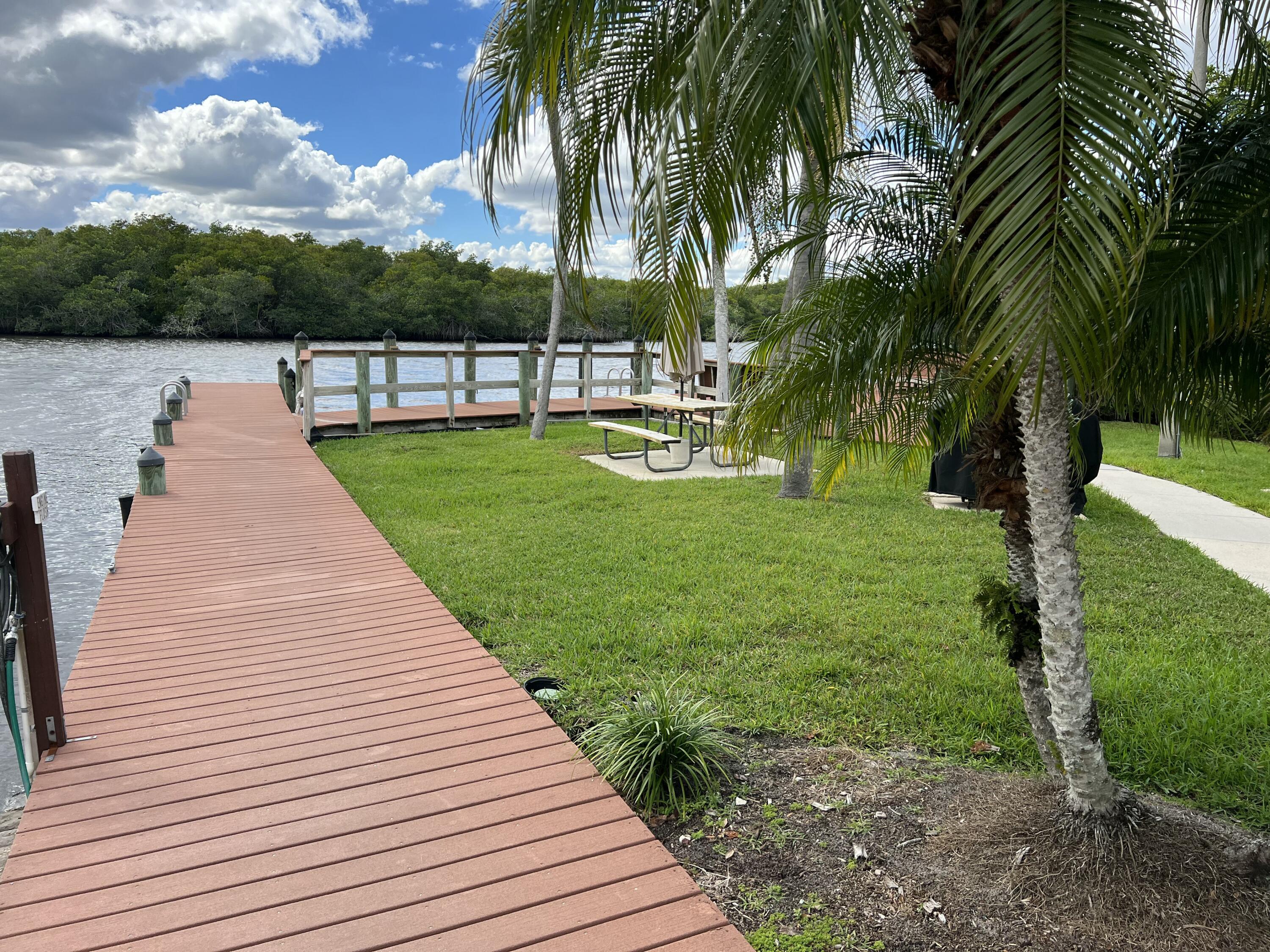 151 Southwest South River Drive, Unit 203 Stuart, FL 34997 - Photo 38 of 54 a view of a garden with palm trees